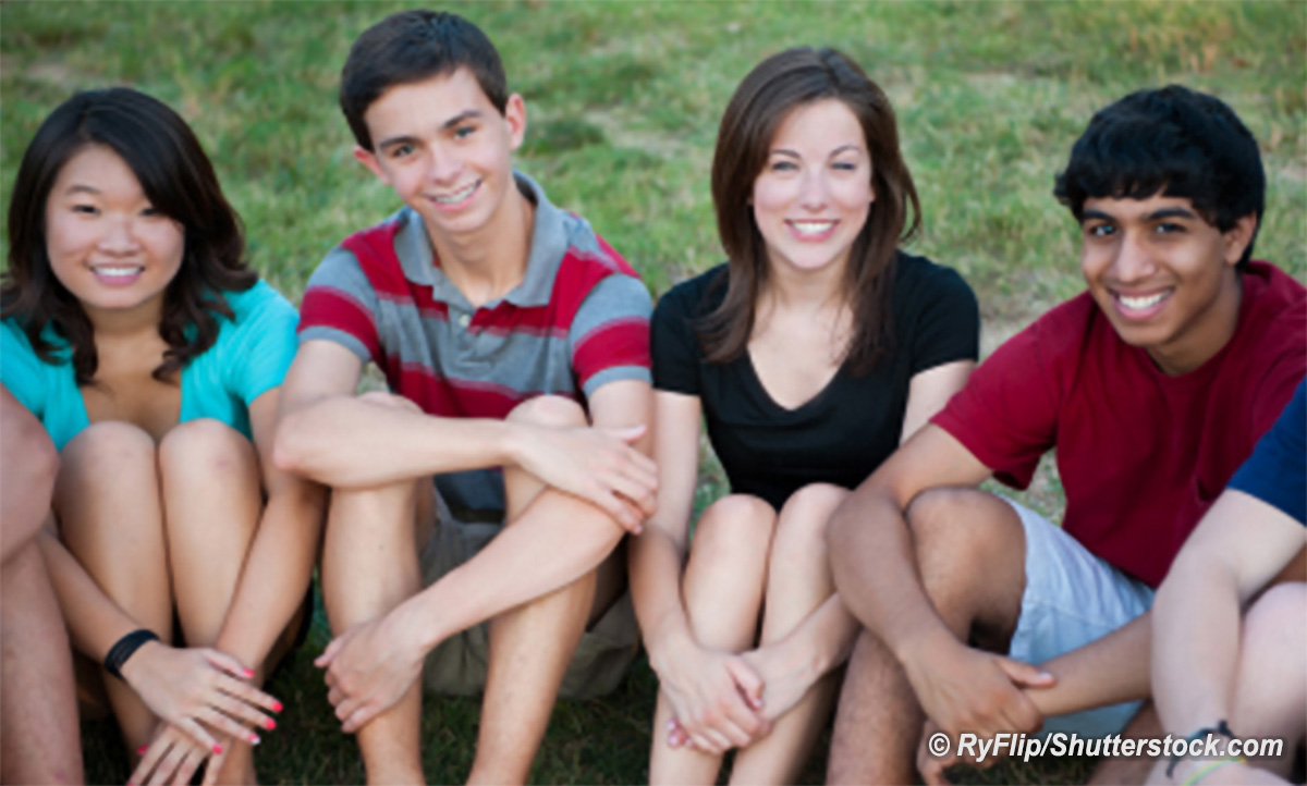 Group of teenagers sitting on the grass