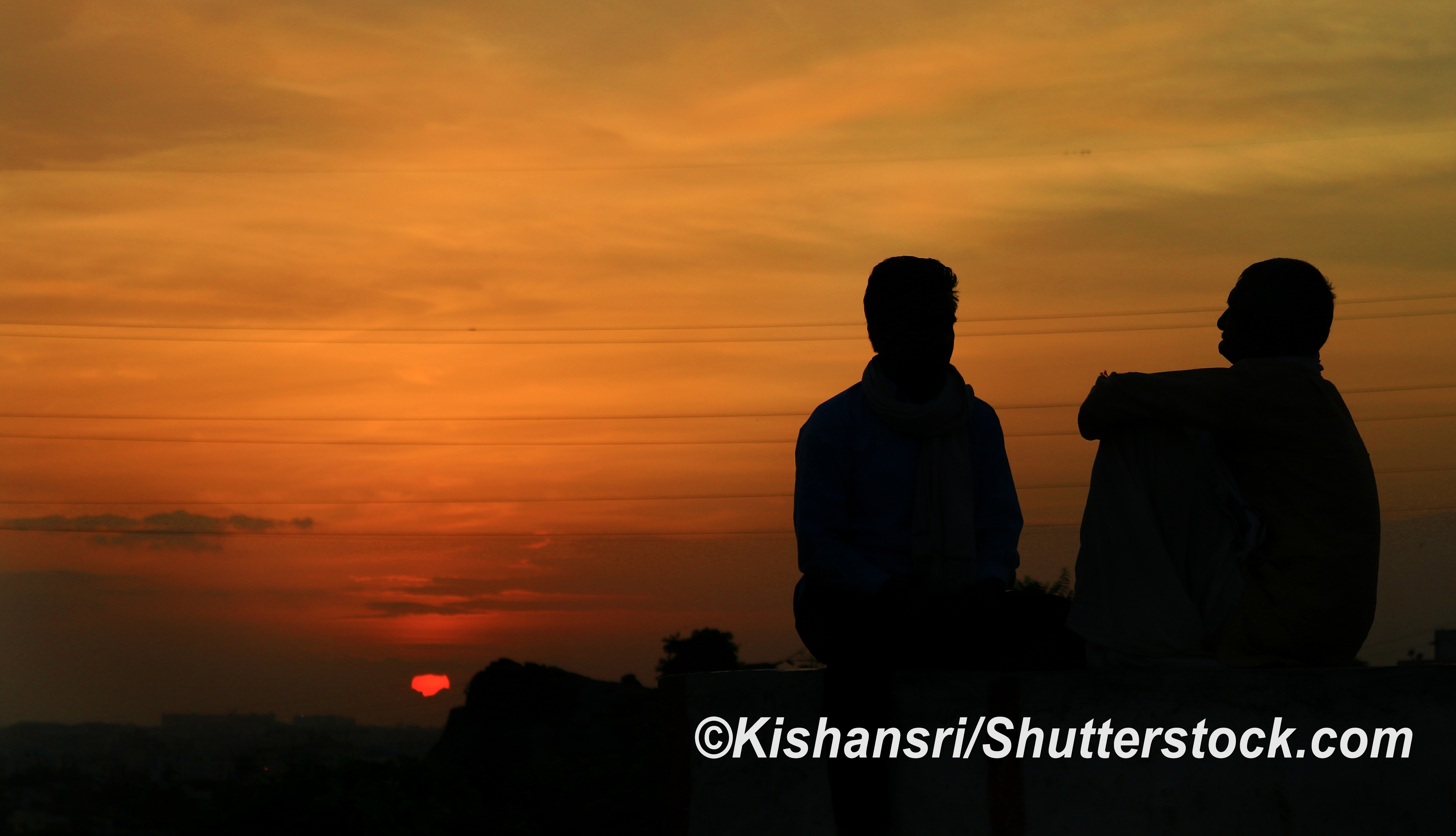 two people silhouettes at sunset