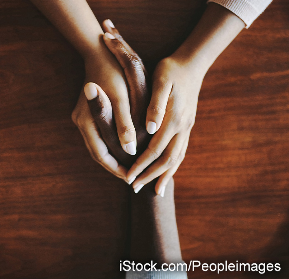 photo of the hands of two individuals embracing