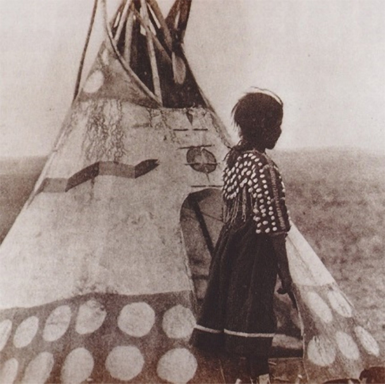 Historical photo of a young female member of the Piegan Indians standing outside her tipi