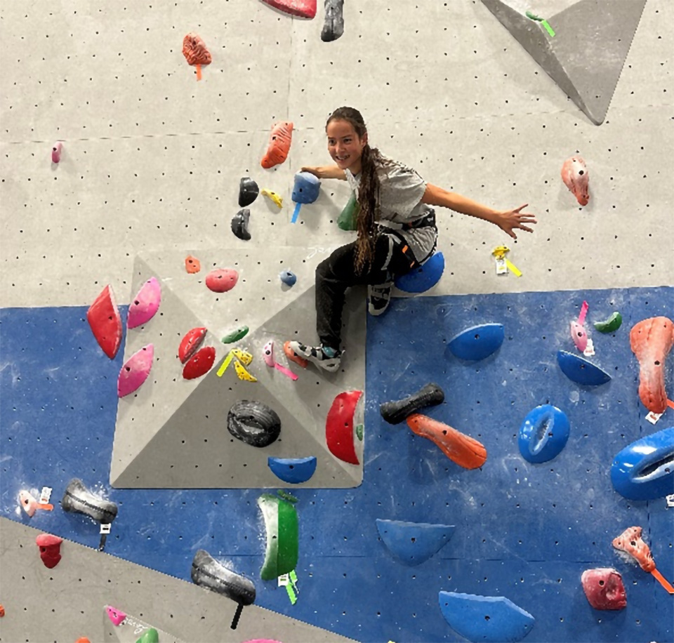 Photo of Project Venture participant in a rock climbing gym