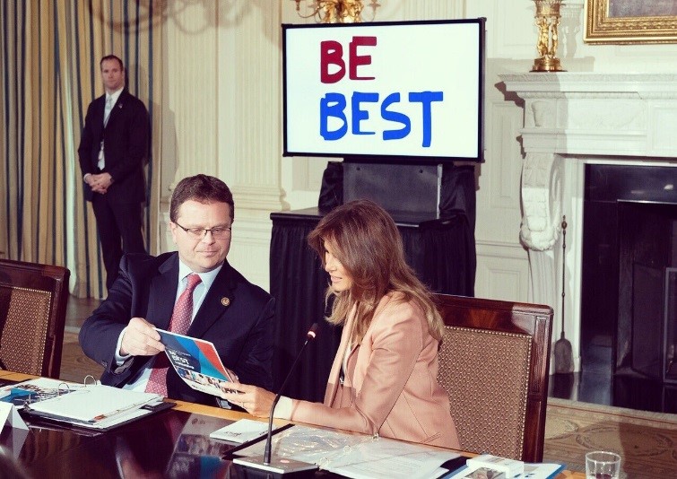 Principal Deputy Assistant Attorney General Matt Dummermuth presents First Lady Melania Trump with a publication describing OJJDP programs that promote the safety and well-being of children and families.