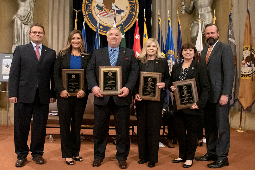 Principal Deputy Assistant Attorney General Matt M. Dummermuth (far left) and Principal Associate Deputy Attorney General Edward C. O’Callaghan (far right) with some of the award recipients.