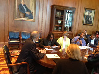 Photo of Attorney General Eric Holder meeting with families of incarcerated youth.