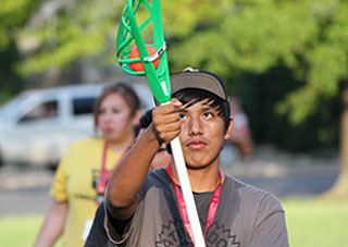 A young man savors the moment of catching the ball during the National Intertribal Youth Summit's lacrosse exhibition and clinic.