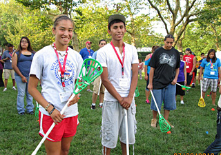 Wyatt Goggle (right), of the Eastern Shoshone Tribe in Wyoming, with a friend at the youth summit's lacrosse clinic.