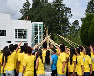 Conference participants play a traditional game of stick ball during Nike N7 Day.