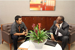 Administrator Listenbee (right) and a summit participant engaged in a one-on-one discussion.