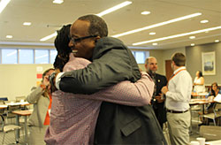 Administrator Listenbee embraces a youth participant.