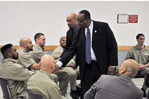 Administrator Listenbee greets inmates at FCI Fort Dix before the roundtable.