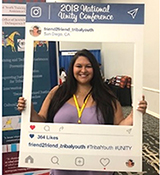Presenter Hilary Hullinger in San Diego, CA, with OJJDP’s Tribal Youth Training and Technical Assistance Center 2018 National Unity Conference Instagram cutout.