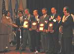 Acting Assistant Attorney General Henke presents the 2005 Officer of the Year Award to five officers from Missouri for their role in the recovery of infant Victoria Stinnet: Special Agent Kurt Lipanovich, Federal Bureau of Investigation, St. Joseph; Investigator Randy Strong, Maryville Department of Public Safety; Sergeant David Merrill and Corporal Jeffrey M. Owen, Missouri State Highway Patrol; and Sheriff Ben Espey, Nodaway County Sheriff's Department. 