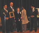 Charles Cogburn of Russellville, AR, received the AMBER Alert Citizen Award for his role in the rescue of 17-year-old Shauna Leigh Owens of Plano, TX, who was kidnapped and held at gunpoint. Shauna and her mother join Attorney General Gonzales and Administrator Flores in honoring Mr. Cogburn. 