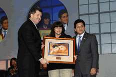 Deputy Postmaster General Patrick Donohue and Attorney General Alberto Gonzales present framed reproduction of AMBER Alert stamp to Donna Norris, Amber Hagerman's mother.
