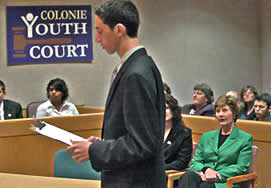 'Prosecutor' Matt Bogdan delivers his opening statement in Youth Court as First Lady Laura Bush and other court attendees listen.