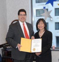 OJJDP Administrator J. Robert Flores poses with Heidi Hsia at her retirement breakfast.