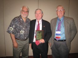 OJJDPs Ron Laney is honored by the American Professional Society on the Abuse of Children (APSAC). From left: APSAC Treasurer Jon Conte, Ph.D., Ron Laney, and APSAC President Michael Haney, Ph.D.