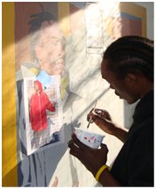 Photo of a teenage boy painting a mural in the City Of Philadelphia's Mural Arts Program.