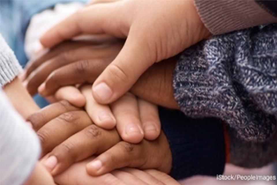 Stock photo of several children stacking their hands together Stock photo of several children stacking their hands together