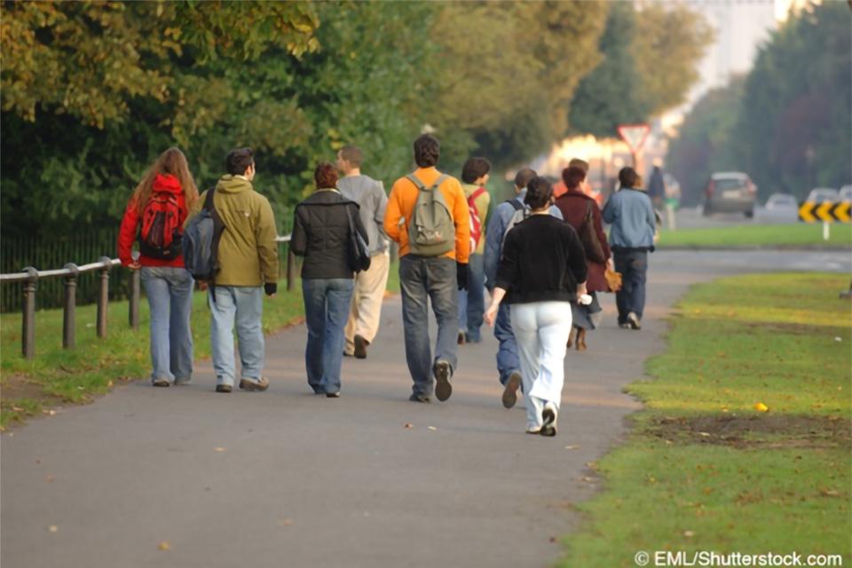 Stock photo of a crowd of youth walking along a path