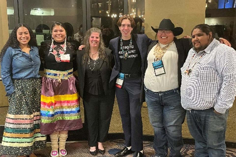 Photo of five youth ambassadors from the Tribal Youth Resource Center—Isabella Fridia, Sydney Matheson, Shace Duncan, Kaitlin Martinez, and Colby WhiteThunder—with OJJDP Administrator Liz Ryan at the Tribal Youth National Conference