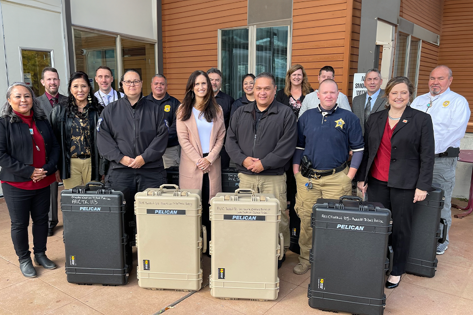 Card - Group photo of AMBER Alert Training and Technical Assistance Program staff presenting technology toolkits to law enforcement officials from six Wisconsin Tribal Nations.