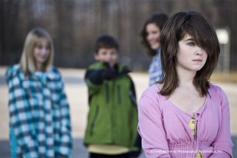 Photo of three children bullying a fourth girl