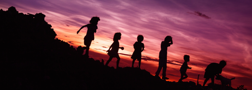 Kids playing at sunset
