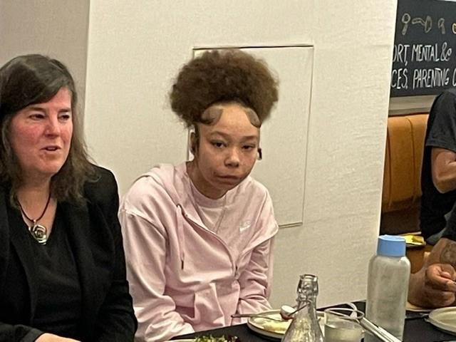 OJJDP Administrator Liz Ryan and youth around the table at the Café Momentum family dinner