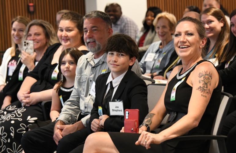 Jax S., the 2025 national poster contest winner with his family and teachers at the 42nd annual National Missing Children's Day Commemoration. 
