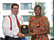 J. Robert Flores offers congratulations to Marilyn Landon on her retirement
