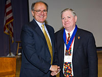 Western New England College President Anthony S. Caprio awards the President's Medallion to Ron Laney, Associate Administrator of OJJDP's Child Protection Division.